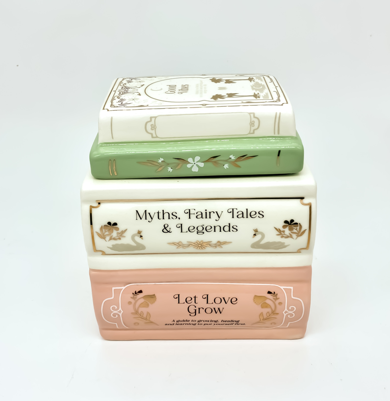 Quemador de Wax melts Un capítulo más, de cerámica con forma de libros apilados en tonos pastel