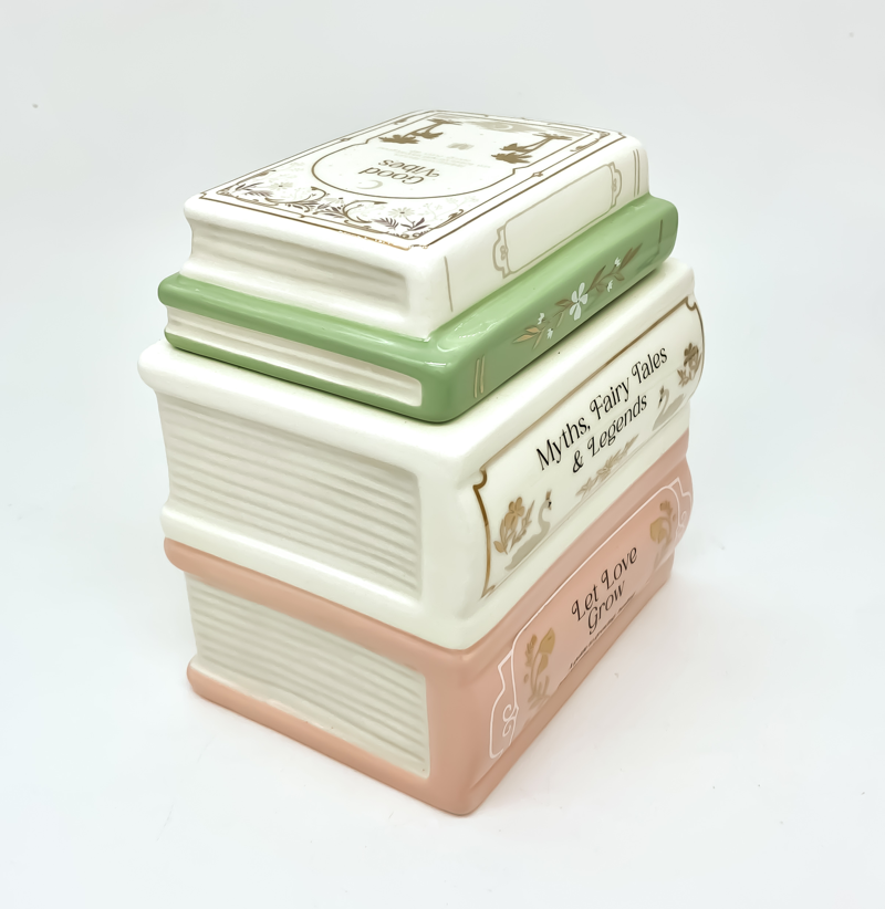 Quemador de wax melts Un capítulo más de cerámica con forma de libros apilados en tonos pastel